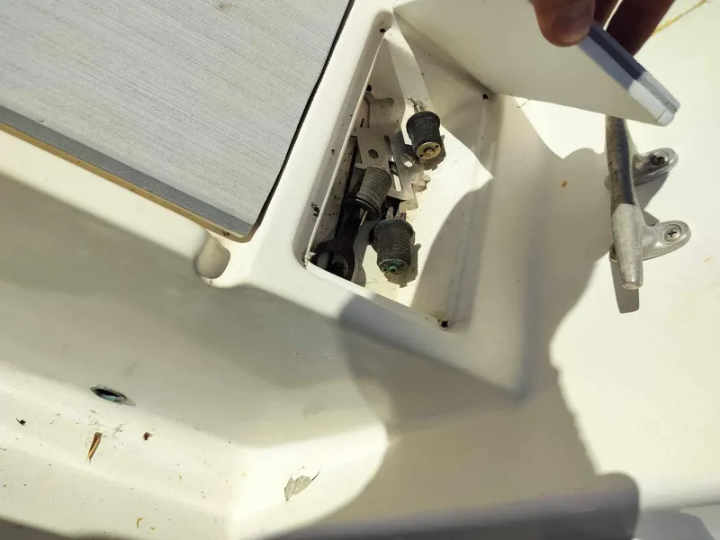 Slide: The Image of 1988 Mako 171 Center Console boat storage compartment with open lid. - 36