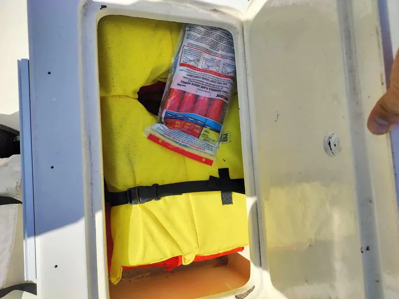 Slide: The Image of Storage compartment of 1988 Mako 171 Center Console with life jacket and safety gear. - 37