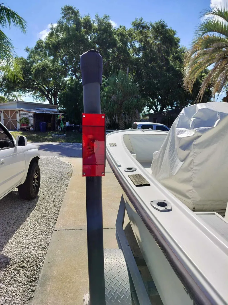 Slide: The Image of 1988 Mako 171 Center Console boat on a trailer in a driveway. - 4