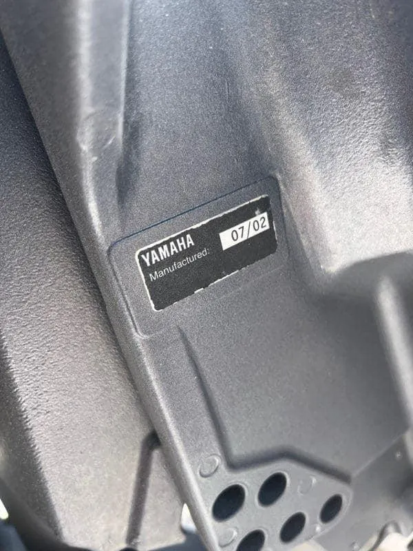 Slide: The Image of Yamaha engine part with manufacturing date label, July 2002, on a 1988 Mako 171 Center Console boat. - 47