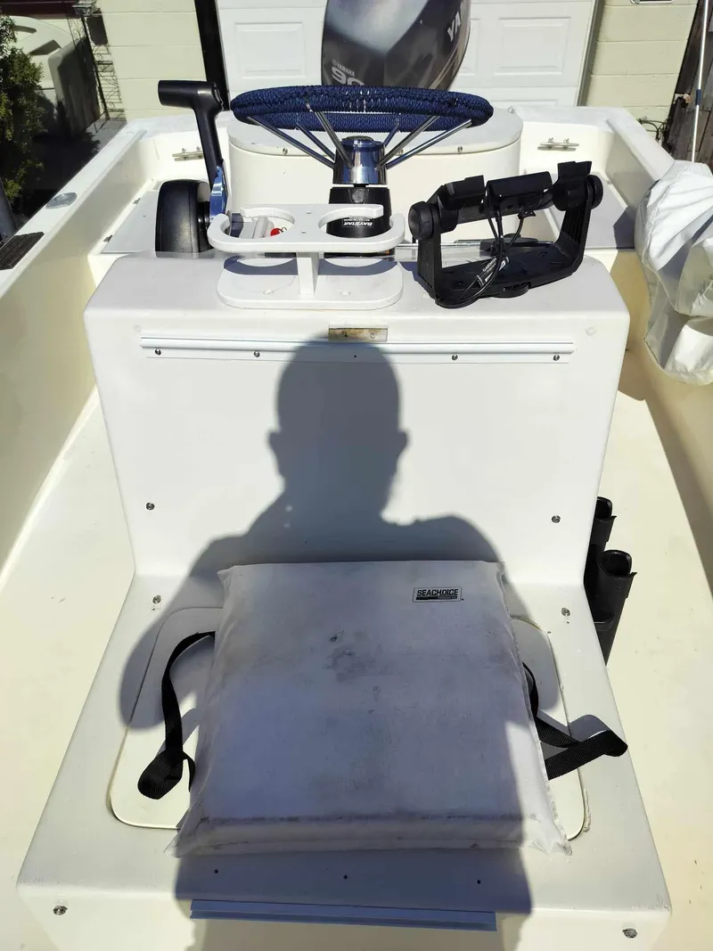 Slide: The Image of 1988 Mako 171 Center Console boat interior with steering wheel and seat. - 6