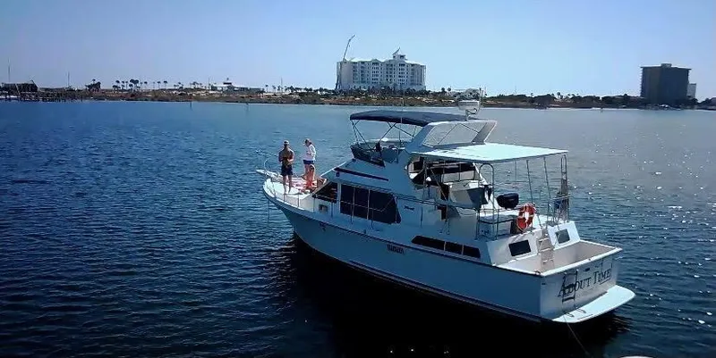 Slide: The Image of 1986 Tollycraft 44 CPMY yacht on calm water with cityscape background. - 0