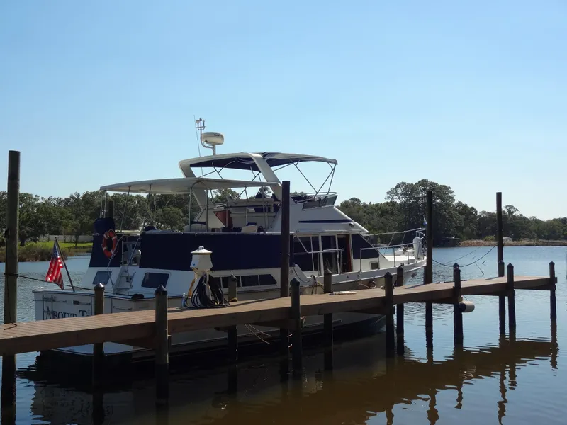 Slide: The Image of 1986 Tollycraft 44 CPMY yacht docked on a sunny day. - 1