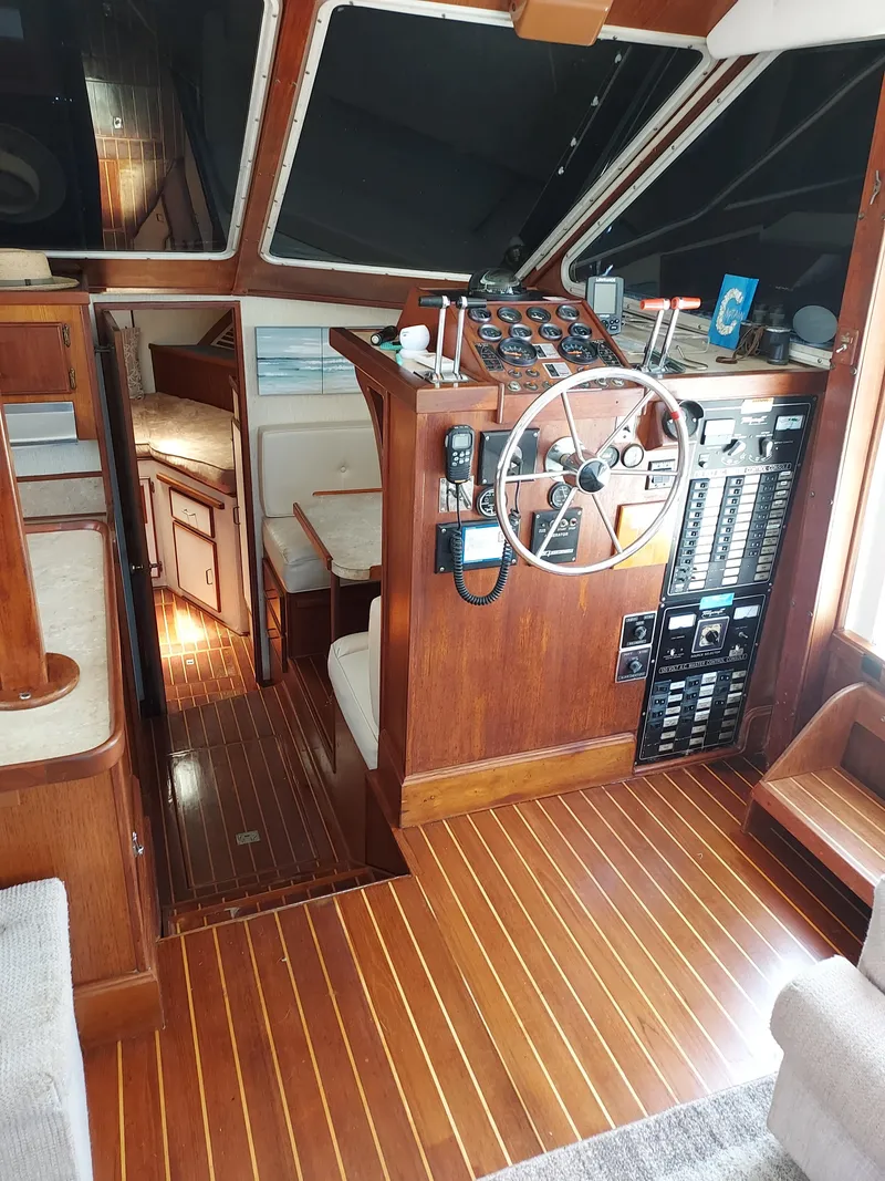 Slide: The Image of Interior of 1986 Tollycraft 44 CPMY yacht with wooden helm and control panel. - 10
