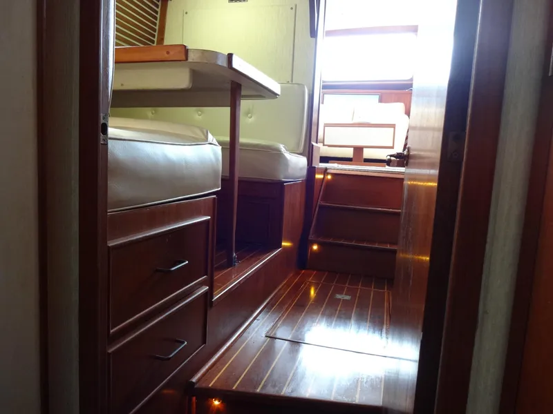 Slide: The Image of Interior of 1986 Tollycraft 44 CPMY yacht with wooden flooring and seating area. - 12