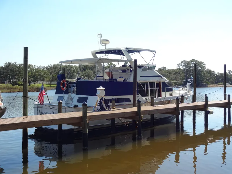Slide: The Image of 1986 Tollycraft 44 CPMY yacht docked at a marina, sunny day. - 13