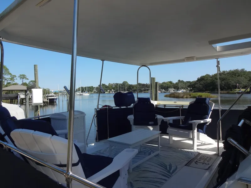 Slide: The Image of 1986 Tollycraft 44 CPMY yacht deck with seating, overlooking serene marina. - 18