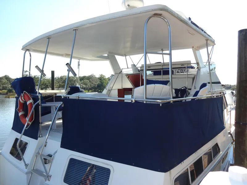 Slide: The Image of 1986 Tollycraft 44 CPMY yacht with blue canopy and life preserver on deck. - 21