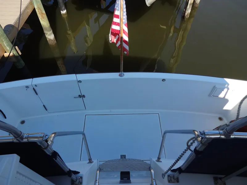 Slide: The Image of 1986 Tollycraft 44 CPMY boat stern with American flag at dock. - 28