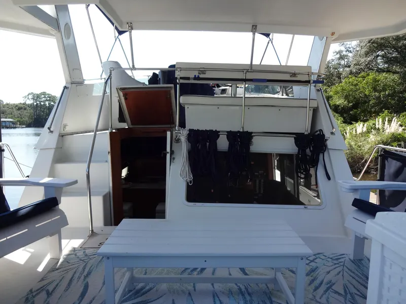 Slide: The Image of 1986 Tollycraft 44 CPMY yacht deck with seating and open cabin door. - 29