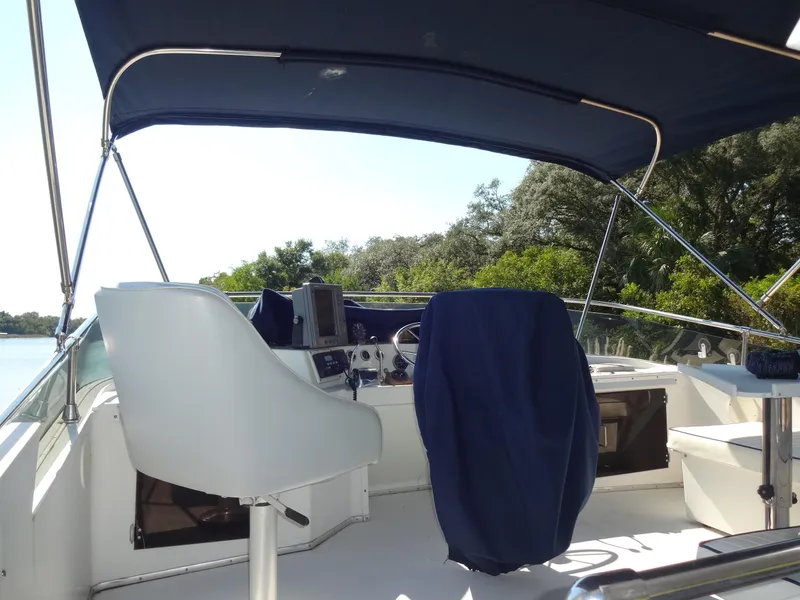 Slide: The Image of 1986 Tollycraft 44 CPMY yacht cockpit with blue canopy and seating. - 32