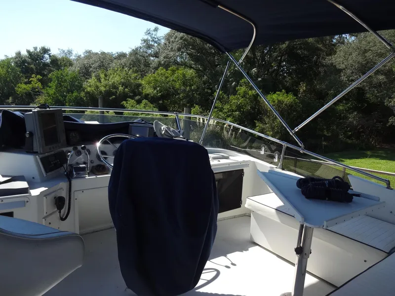 Slide: The Image of 1986 Tollycraft 44 CPMY yacht cockpit with steering wheel and navigation equipment. - 33