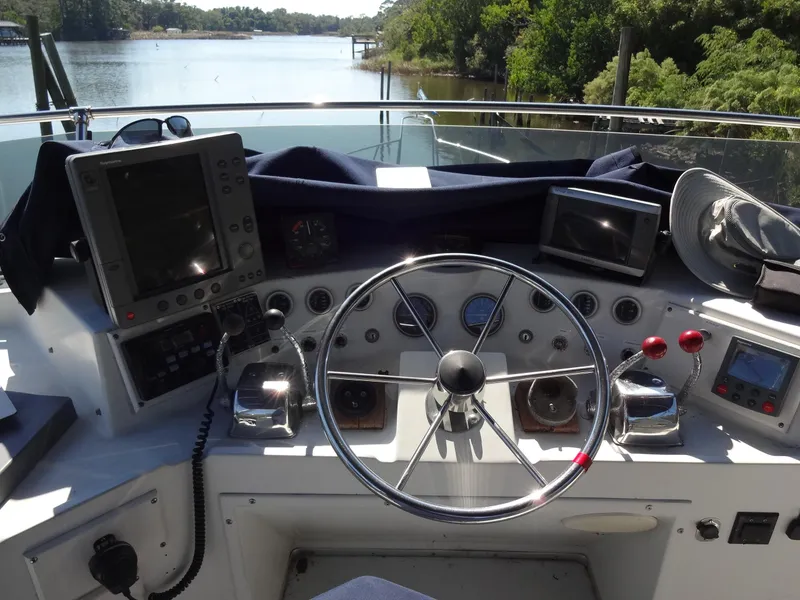 Slide: The Image of Helm of 1986 Tollycraft 44 CPMY yacht with navigational equipment and steering wheel. - 34