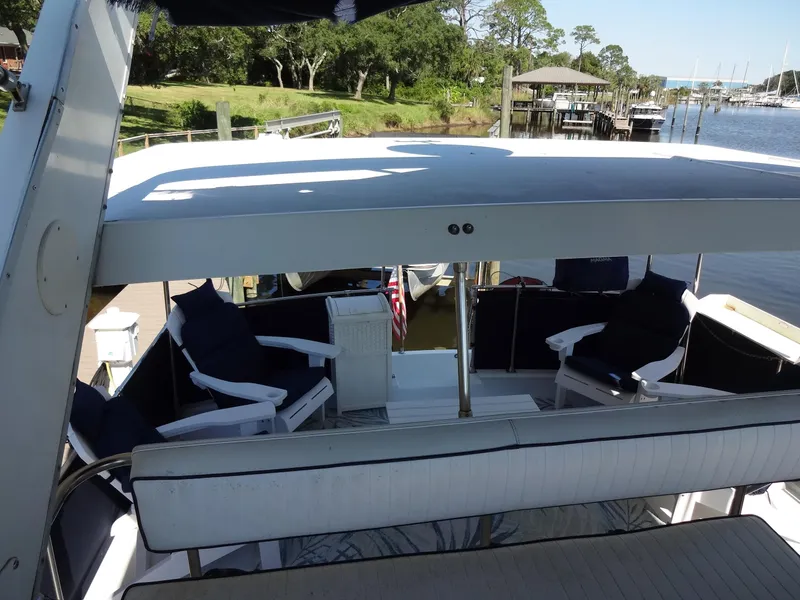Slide: The Image of 1986 Tollycraft 44 CPMY yacht with spacious deck and seating area by the water. - 36