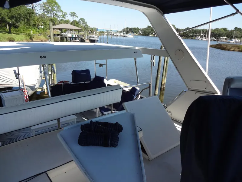 Slide: The Image of 1986 Tollycraft 44 CPMY yacht docked at a serene marina. - 37