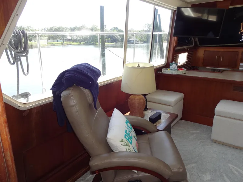 Slide: The Image of Interior of 1986 Tollycraft 44 CPMY yacht with leather chair, lamp, and large window view. - 42