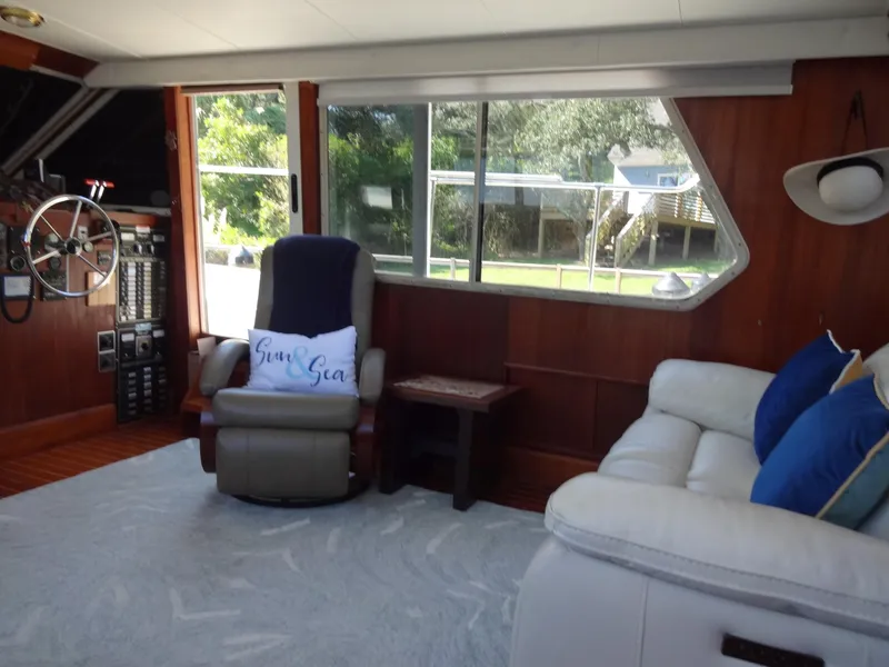 Slide: The Image of Interior of 1986 Tollycraft 44 CPMY yacht with cozy seating and large windows. - 43