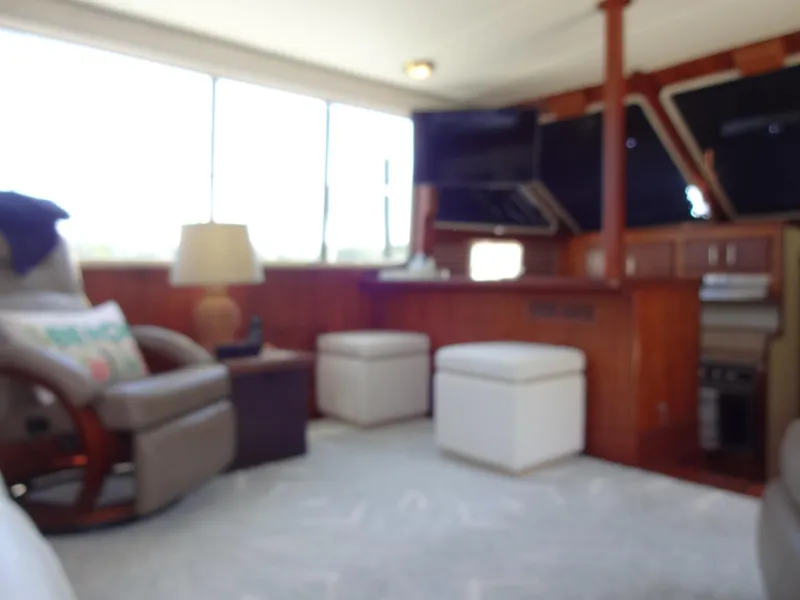 Slide: The Image of Interior of 1986 Tollycraft 44 CPMY yacht with cozy seating and wooden accents. - 44