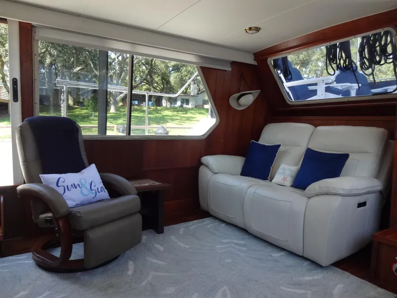 Slide: The Image of Interior of 1986 Tollycraft 44 CPMY yacht with cozy seating and scenic window views. - 47