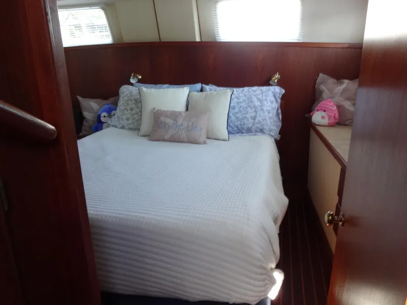 Slide: The Image of Cozy bedroom in 1986 Tollycraft 44 CPMY yacht with plush pillows and wooden accents. - 48