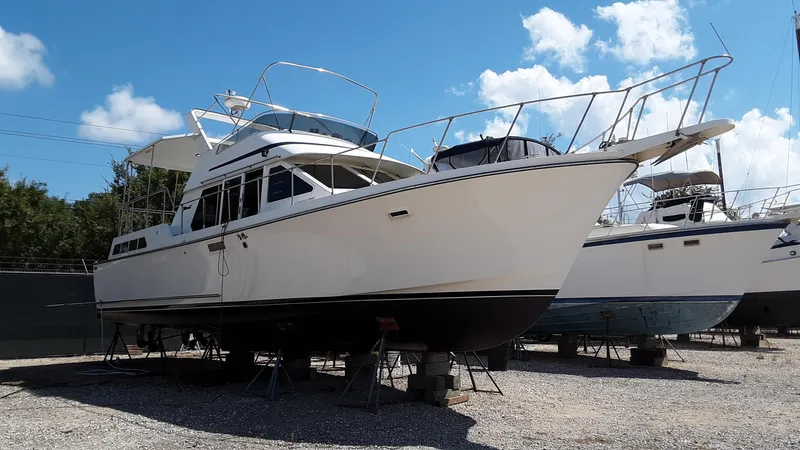 Slide: The Image of 1986 Tollycraft 44 CPMY yacht on dry dock under clear blue sky. - 6