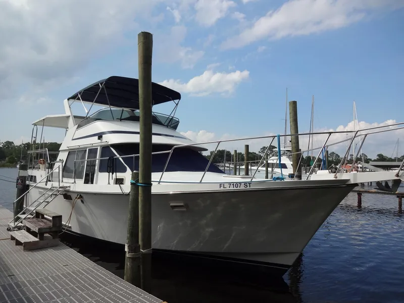 Slide: The Image of 1986 Tollycraft 44 CPMY yacht docked at marina under blue sky. - 8