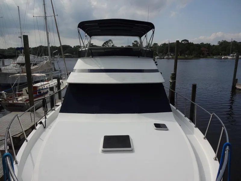 Slide: The Image of 1986 Tollycraft 44 CPMY yacht docked at marina under cloudy sky. - 9