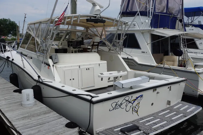 The Image of 2002 Carolina Classic 35 boat docked, featuring spacious deck and fishing equipment. - 0