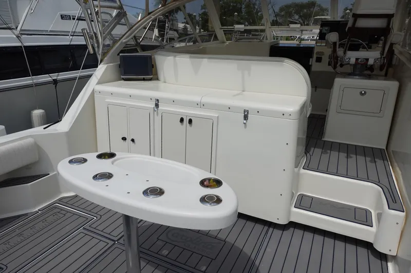 Slide: The Image of 2002 Carolina Classic 35 boat interior with seating, table, and storage cabinets. - 12