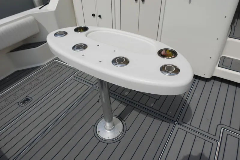 Slide: The Image of 2002 Carolina Classic 35 boat deck with rod holders and non-slip flooring. - 13