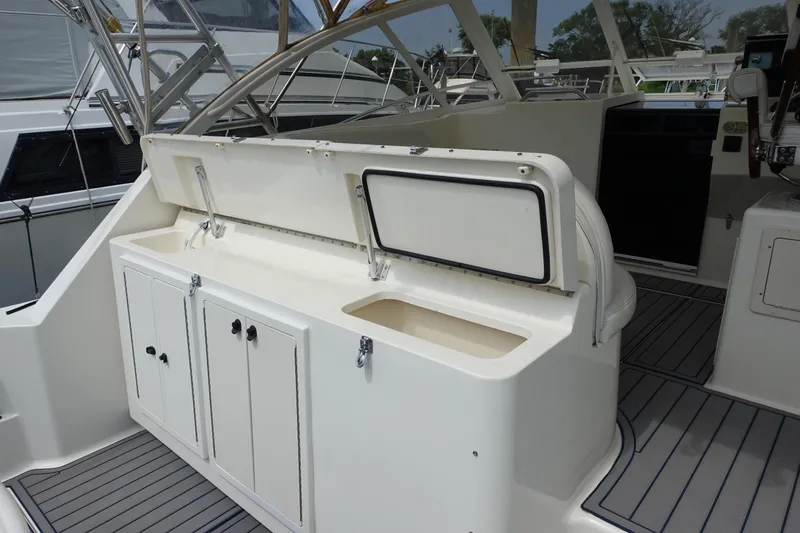 Slide: The Image of 2002 Carolina Classic 35 boat interior with storage compartments and seating area. - 14