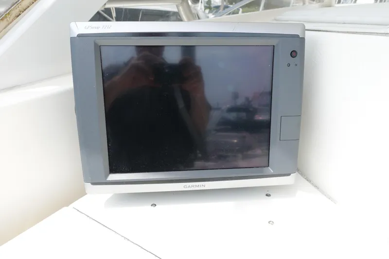 Slide: The Image of Garmin GPS device on 2002 Carolina Classic 35 boat dashboard. - 18
