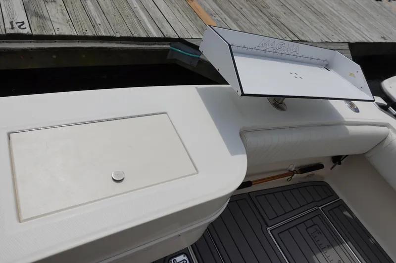 Slide: The Image of 2002 Carolina Classic 35 boat deck with storage compartment and cutting board. - 20