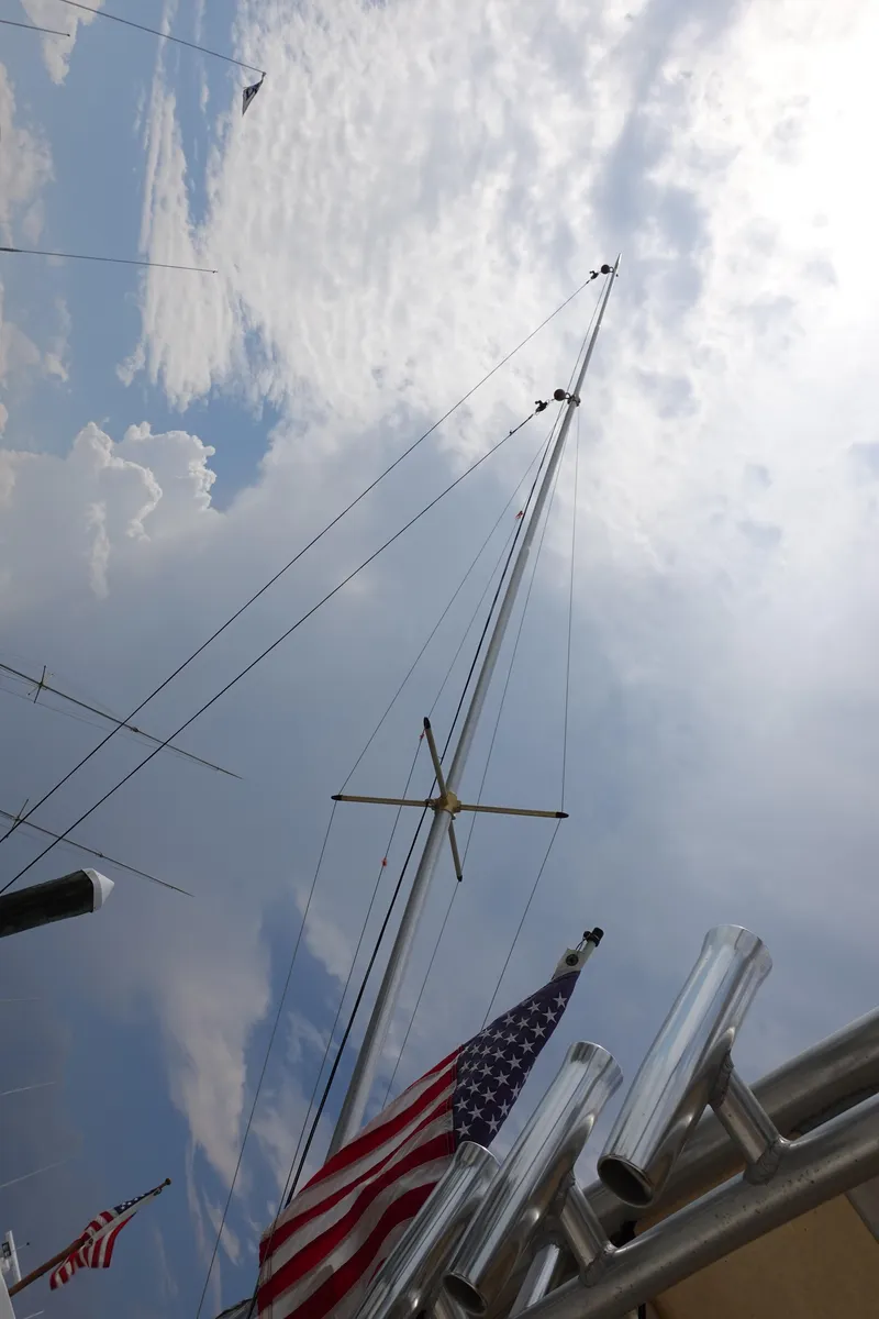 Slide: The Image of Mast of 2002 Carolina Classic 35 boat with American flag against cloudy sky. - 21