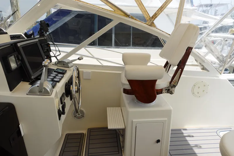 Slide: The Image of Helm station of 2002 Carolina Classic 35 boat with captain's chair and controls. - 23