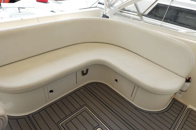 Slide: The Image of 2002 Carolina Classic 35 boat with white cushioned seating and teak flooring. - 27