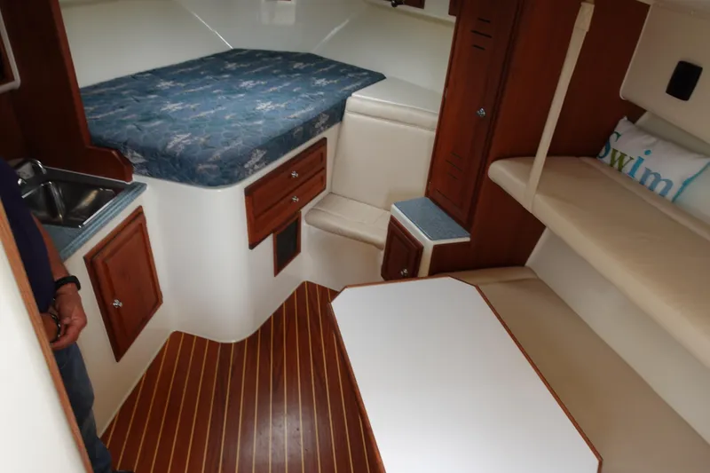 Slide: The Image of Interior of 2002 Carolina Classic 35 boat with bed, seating, and wood flooring. - 33