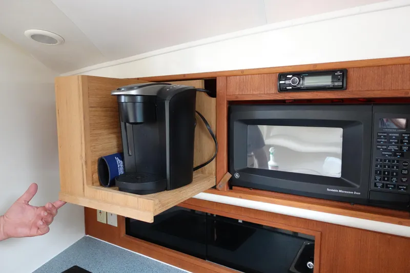 Slide: The Image of 2002 Carolina Classic 35 interior with coffee maker, microwave, and stereo system. - 36