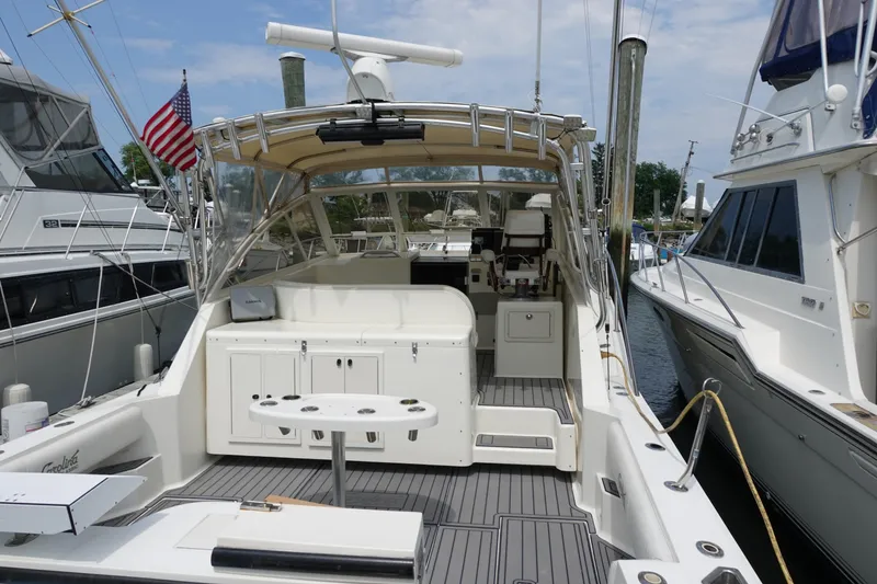 Slide: The Image of 2002 Carolina Classic 35 boat docked, featuring spacious deck and fishing amenities. - 4