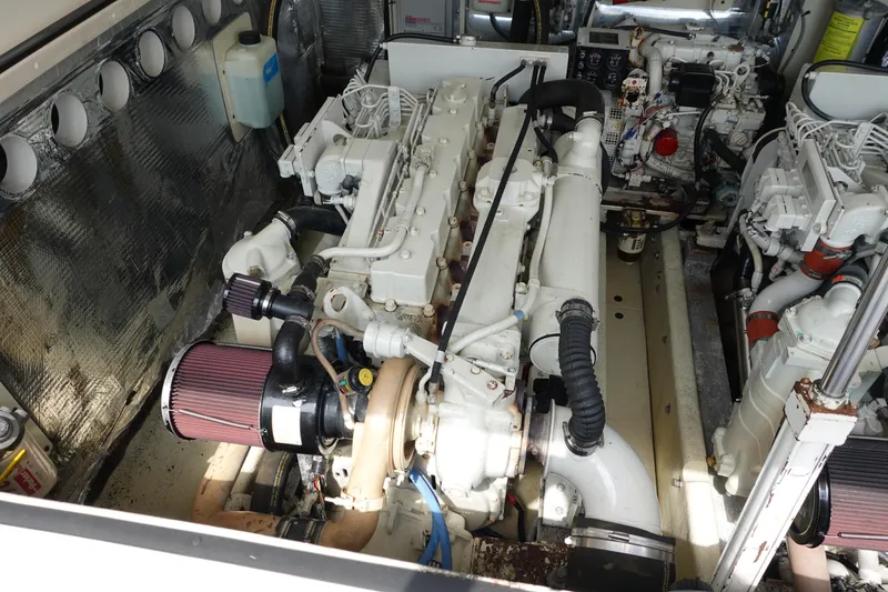 Slide: The Image of Engine room of a 2002 Carolina Classic 35 boat, showcasing dual engines and mechanical components. - 41