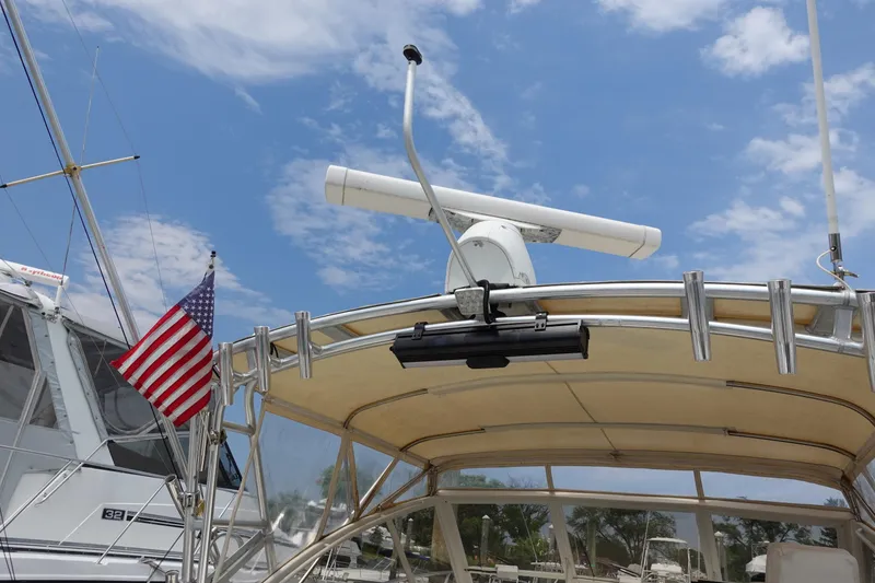 Slide: The Image of 2002 Carolina Classic 35 boat with radar and American flag under a blue sky. - 9