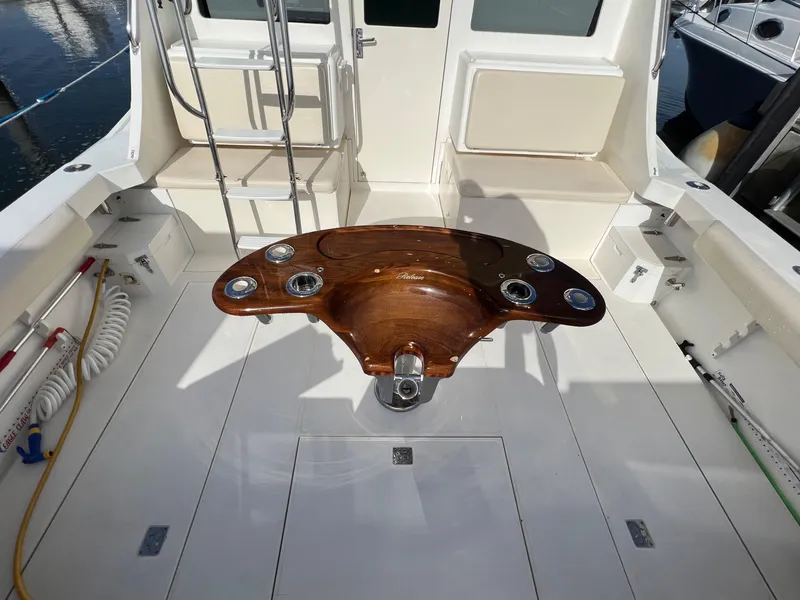 Slide: The Image of 2000 Cabo 35 Flybridge Sportfisher cockpit with fishing rod holders and ladder. - 11