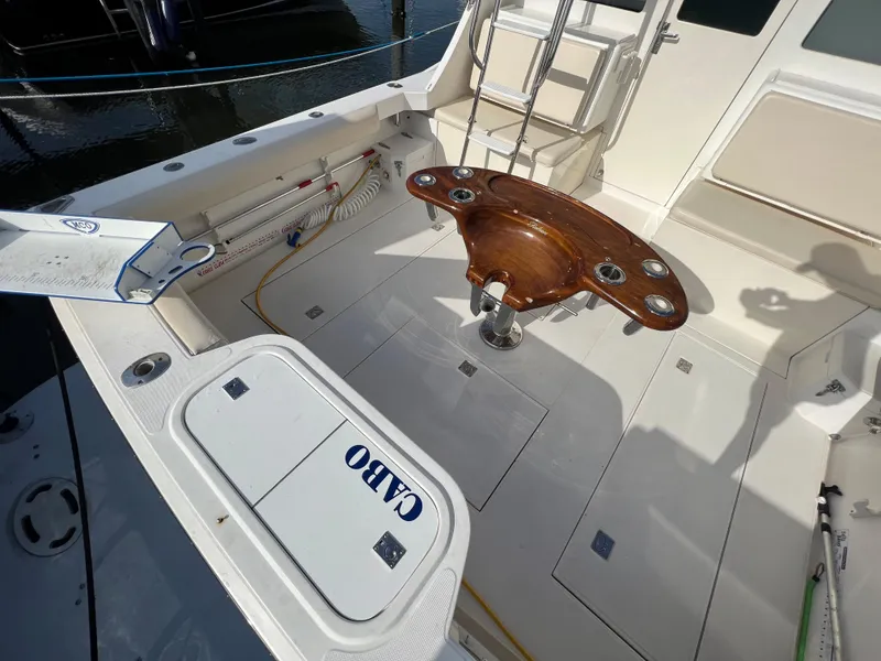 Slide: The Image of 2000 Cabo 35 Flybridge Sportfisher boat deck with fishing chair and storage compartments. - 12
