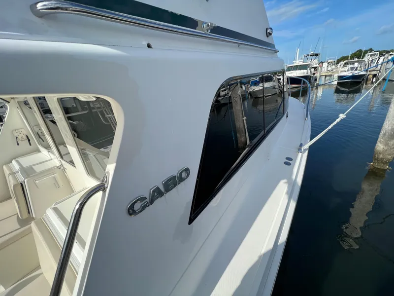 Slide: The Image of Cabo 35 Flybridge Sportfisher 2000 docked at marina, side view. - 14