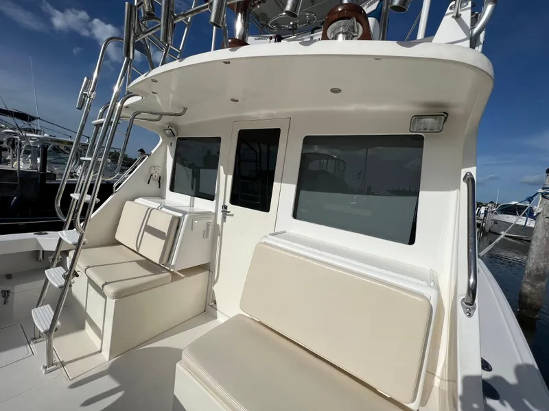 Slide: The Image of 2000 Cabo 35 Flybridge Sportfisher boat with seating and ladder, docked at marina. - 15