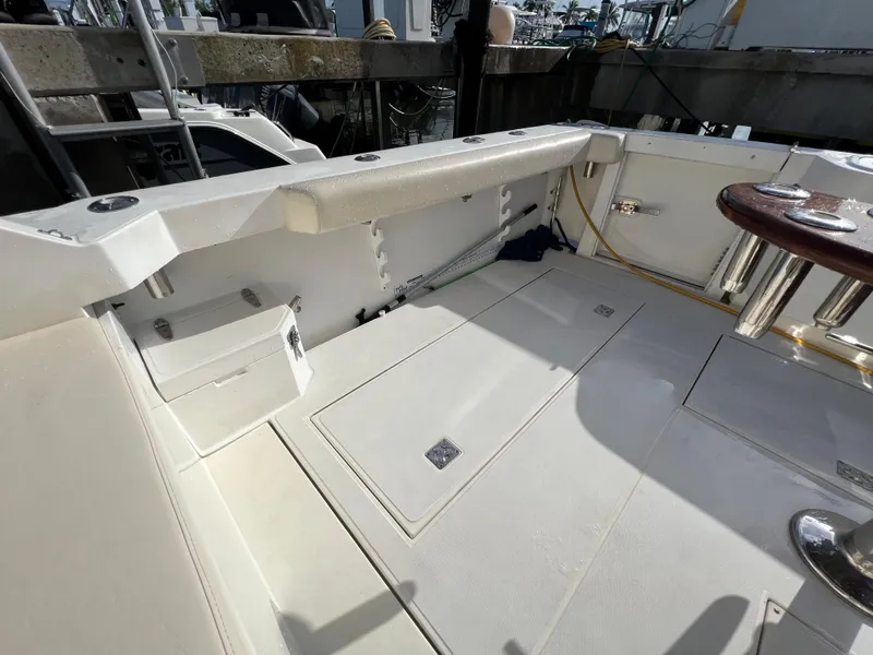 Slide: The Image of 2000 Cabo 35 Flybridge Sportfisher boat deck with storage compartments and seating. - 17