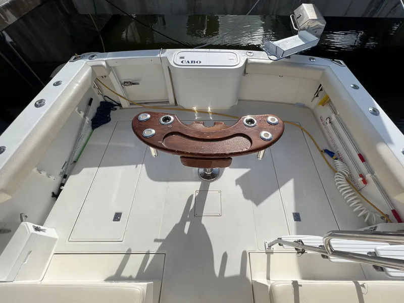 Slide: The Image of 2000 Cabo 35 Flybridge Sportfisher boat deck with fishing chair and storage compartments. - 18