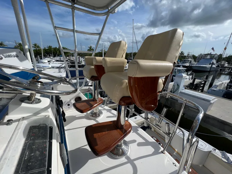 Slide: The Image of Luxury seating on 2000 Cabo 35 Flybridge Sportfisher at marina. - 21