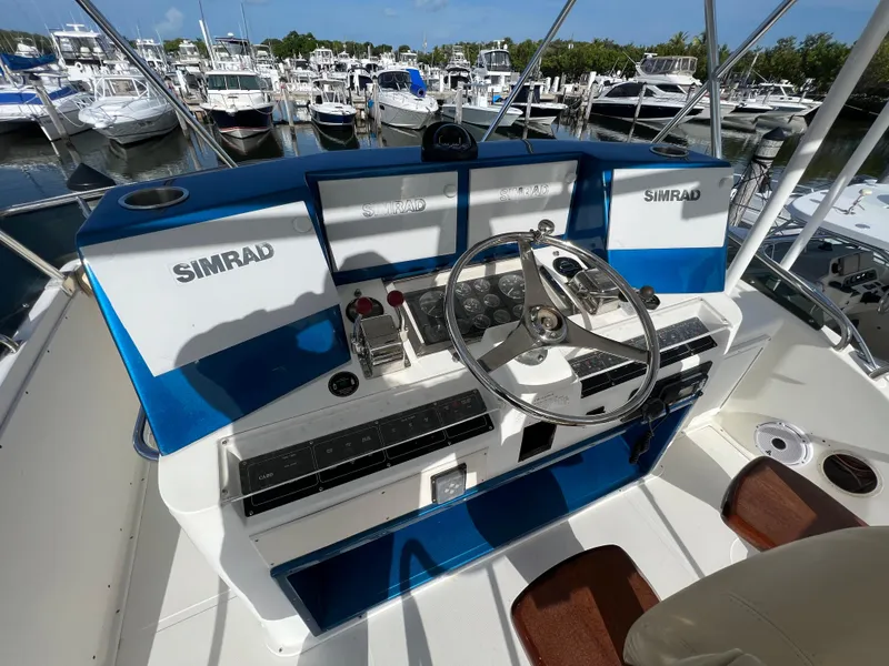 Slide: The Image of Helm of 2000 Cabo 35 Flybridge Sportfisher with Simrad electronics at marina. - 26
