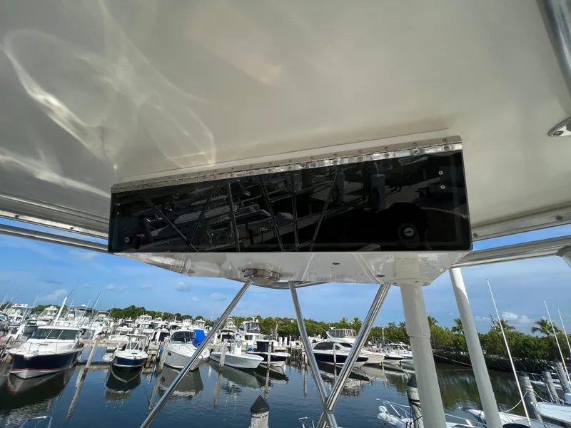 Slide: The Image of Cabo 35 Flybridge Sportfisher 2000 model at a marina with multiple boats. - 27